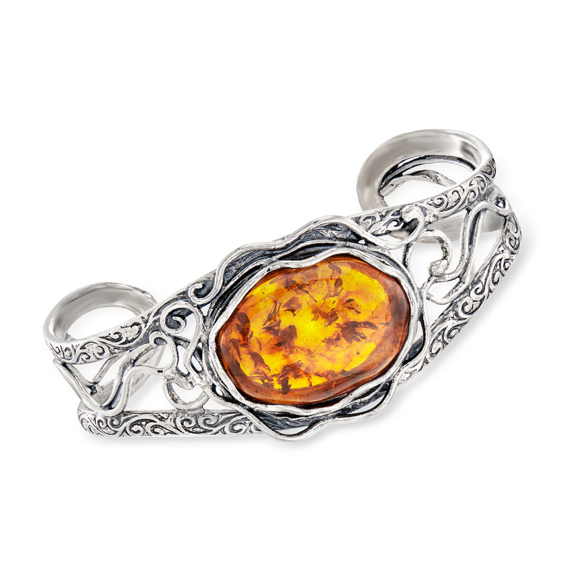 Sterling silver openwork cuff bracelet with oval amber glass cabochon centerpiece