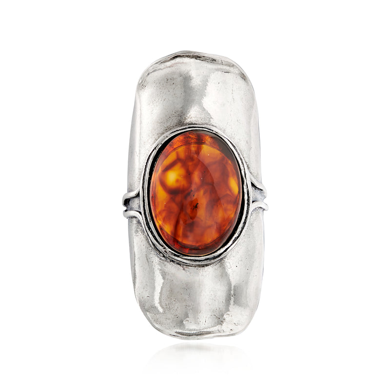 Sterling silver amber oval ring with raised orange-brown cabochon setting
