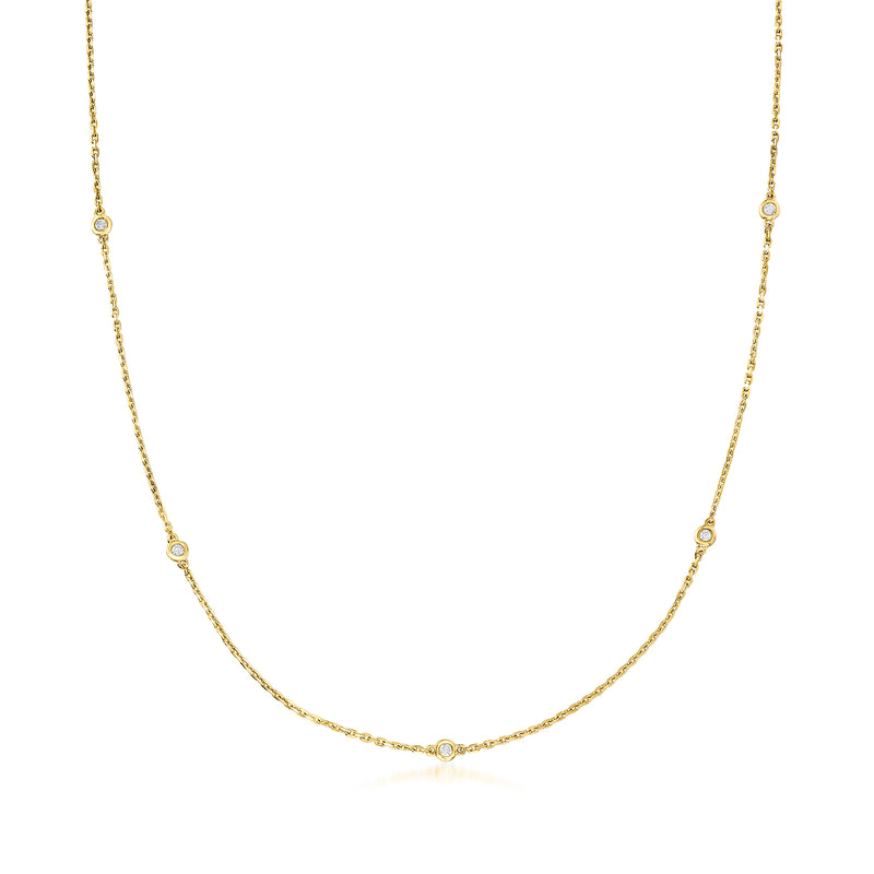 Gold station necklace with small bezel-set diamond links along the chain