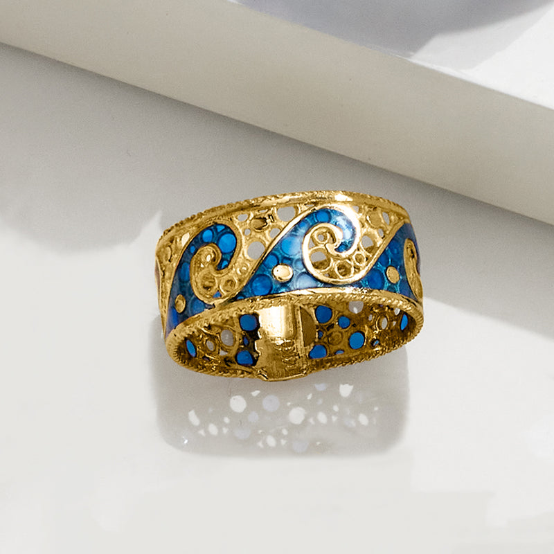 Gold wave ring with blue enamel inlay and decorative filigree on the band