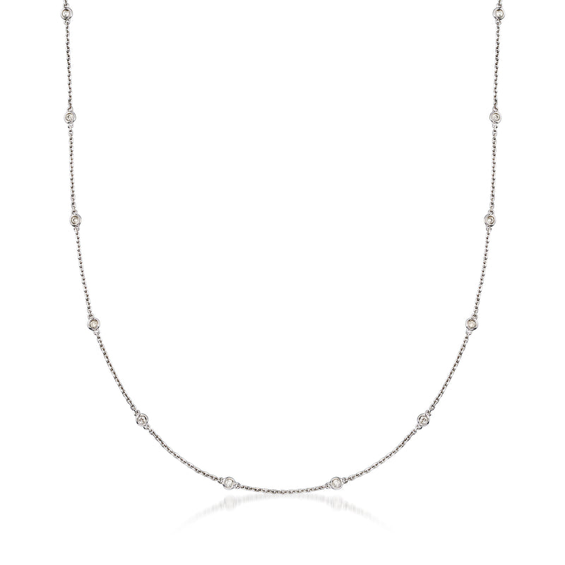 Sterling silver diamond station necklace with bezel-set round stones along a thin chain.