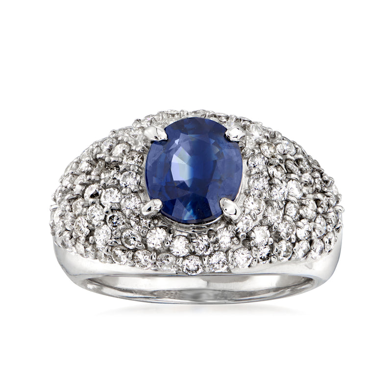 Vintage platinum ring with blue oval sapphire and diamond pave halo
