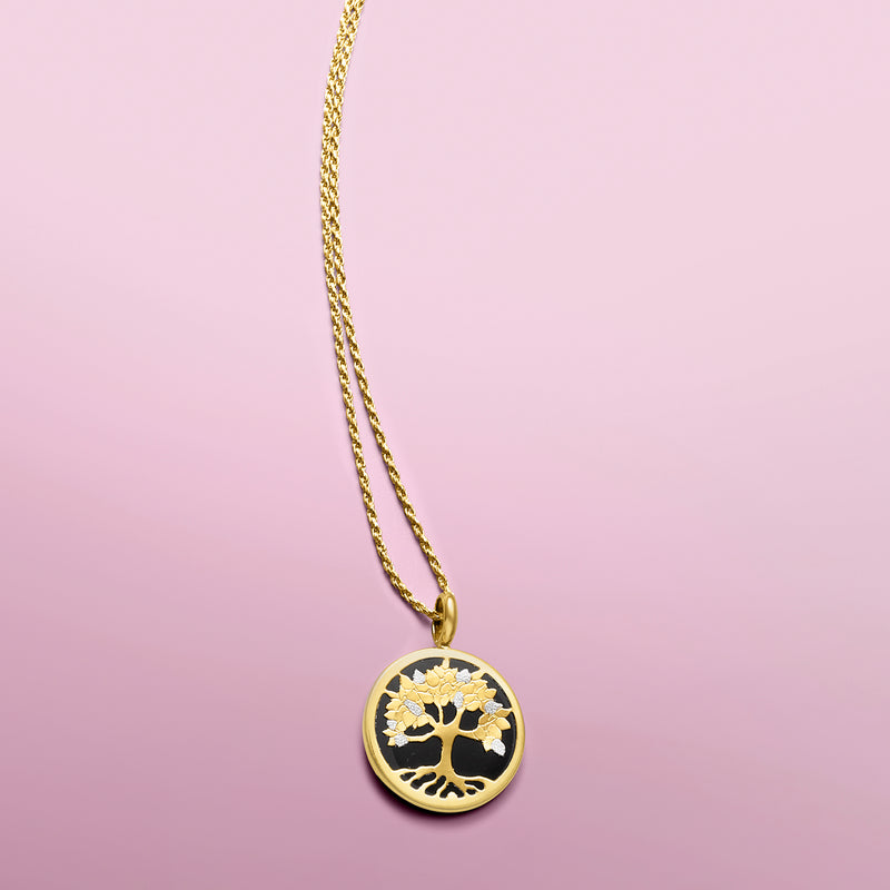 Round Tree of Life pendant with black center, gold tree, and gold chain