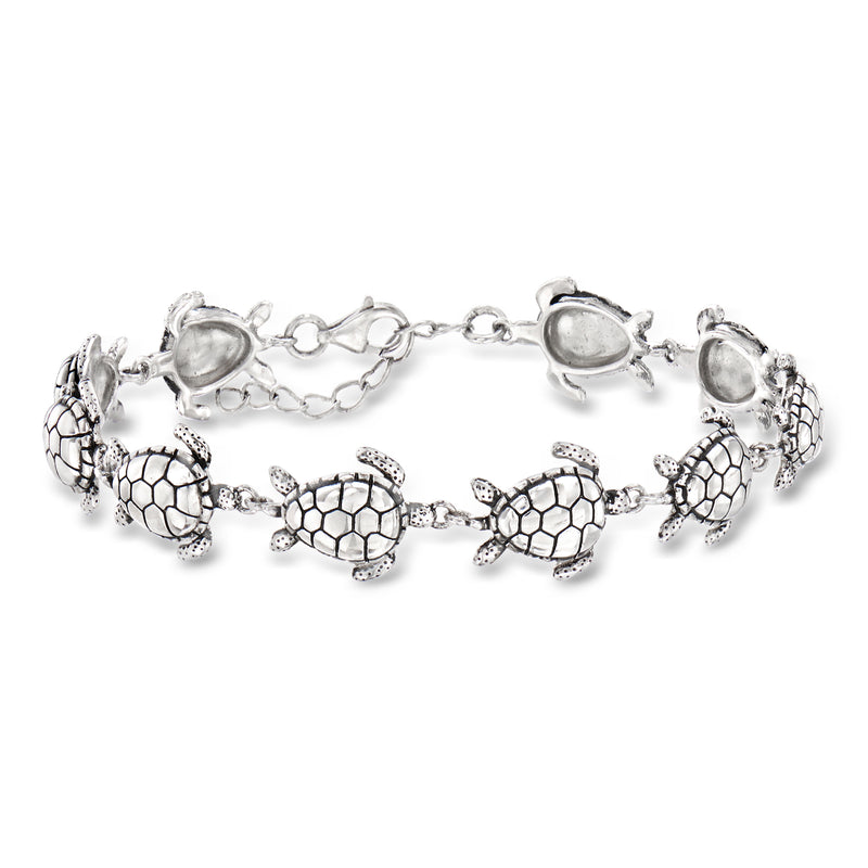 Silver sea turtle charm bracelet with five turtle links and small oval center accents