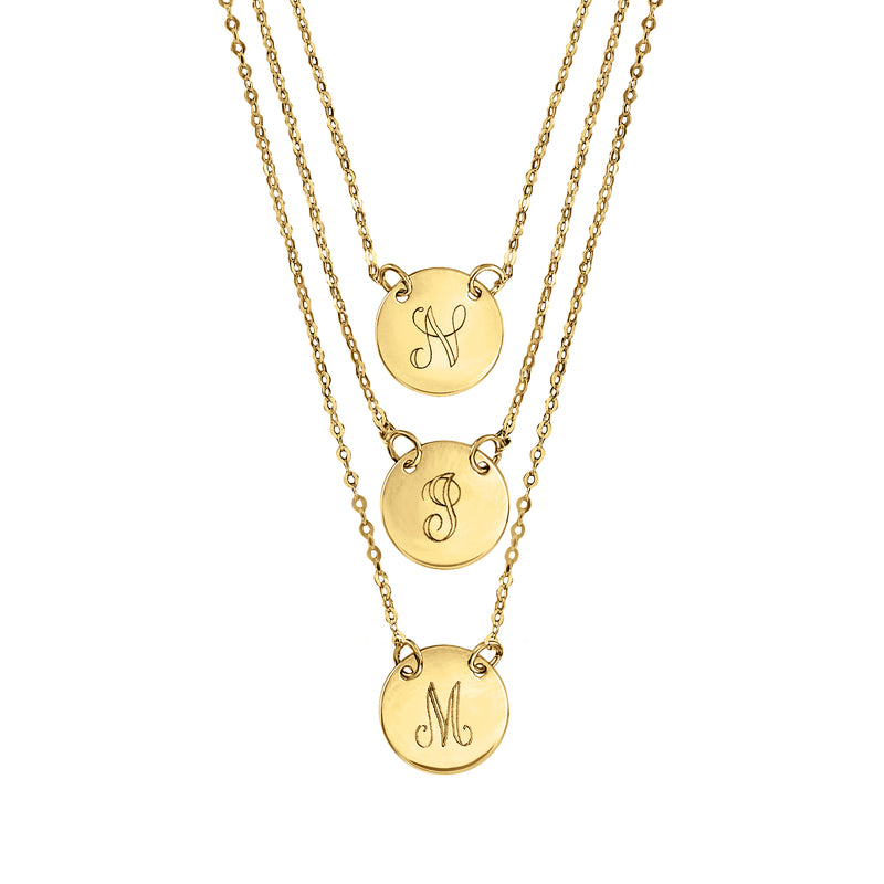 Layered yellow gold initial disc necklace with three engraved round pendants