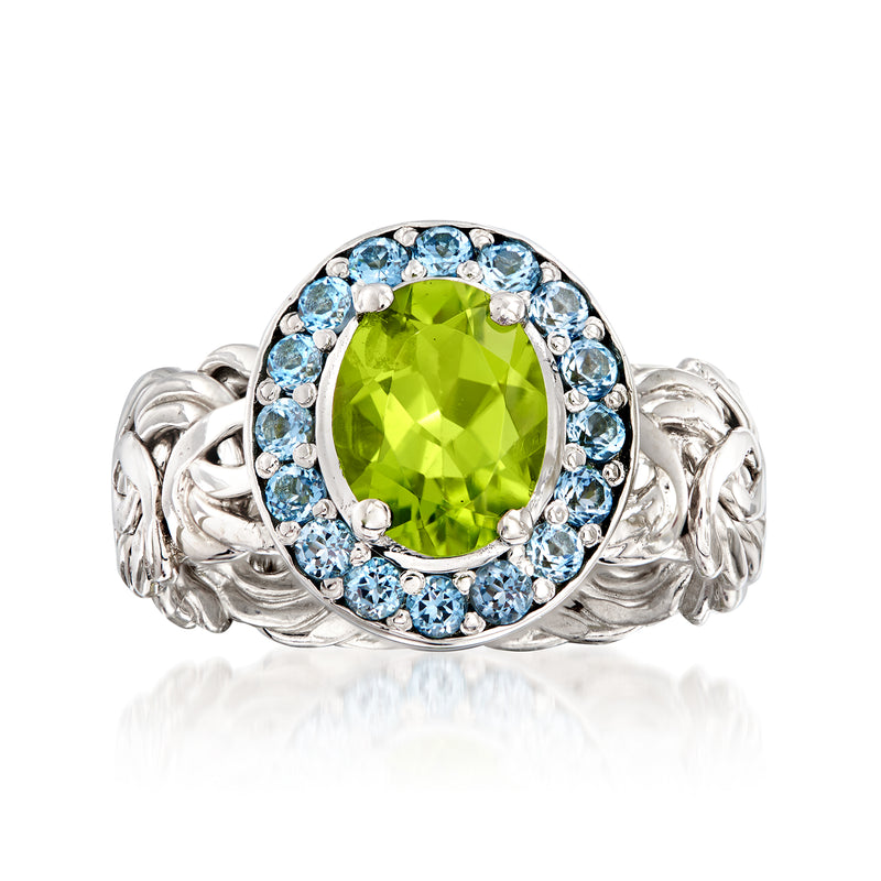 Sterling silver Byzantine ring with green peridot center and blue topaz halo