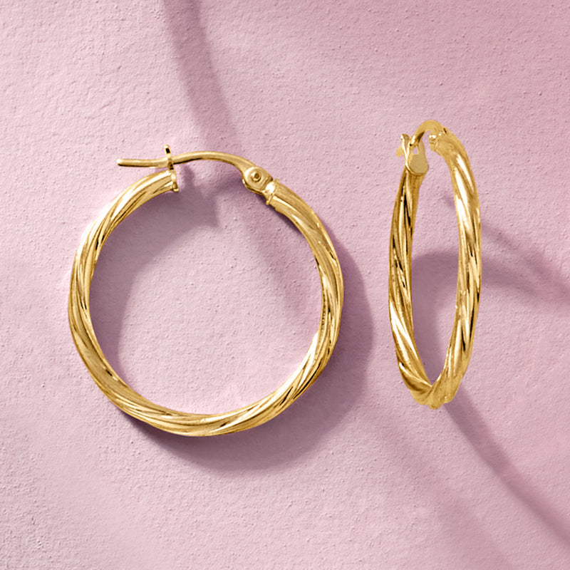 Twisted hoop earrings in 14kt yellow gold with hinge clasp and ridged twist detail