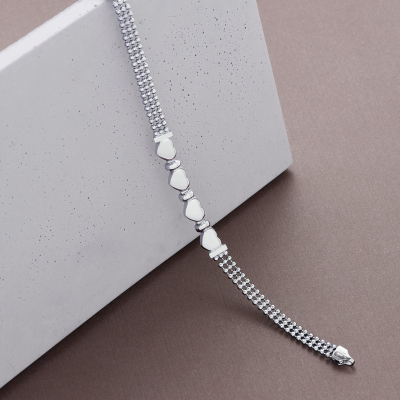 Sterling silver heart beaded bracelet with repeating heart charms on a beaded chain