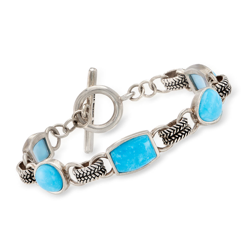 Sterling silver bracelet with oval turquoise blue stones and braided links, toggle clasp.
