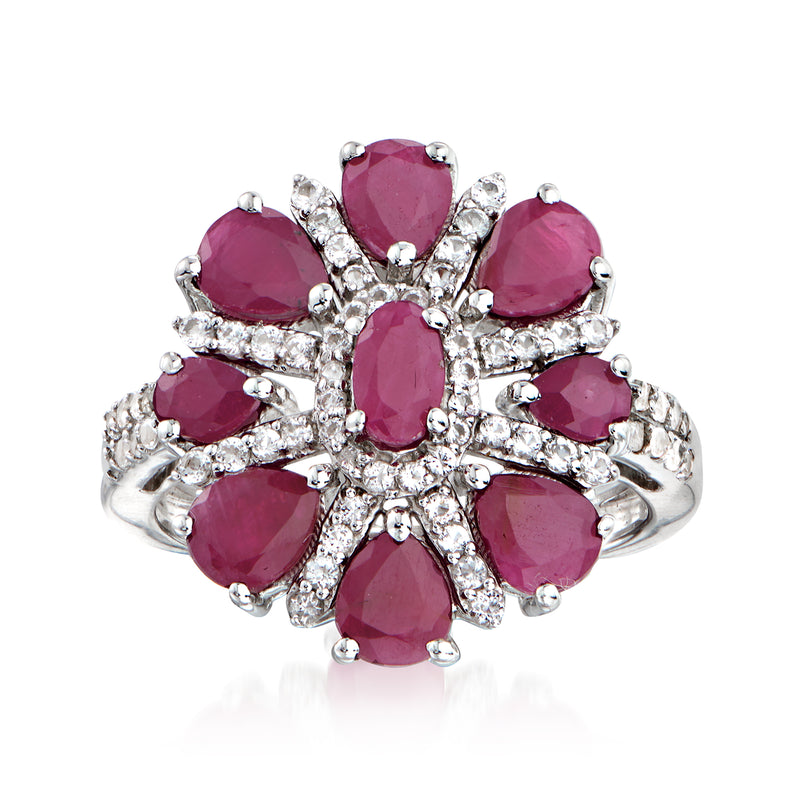 Sterling silver flower ring with ruby center and round white topaz accents, prong set
