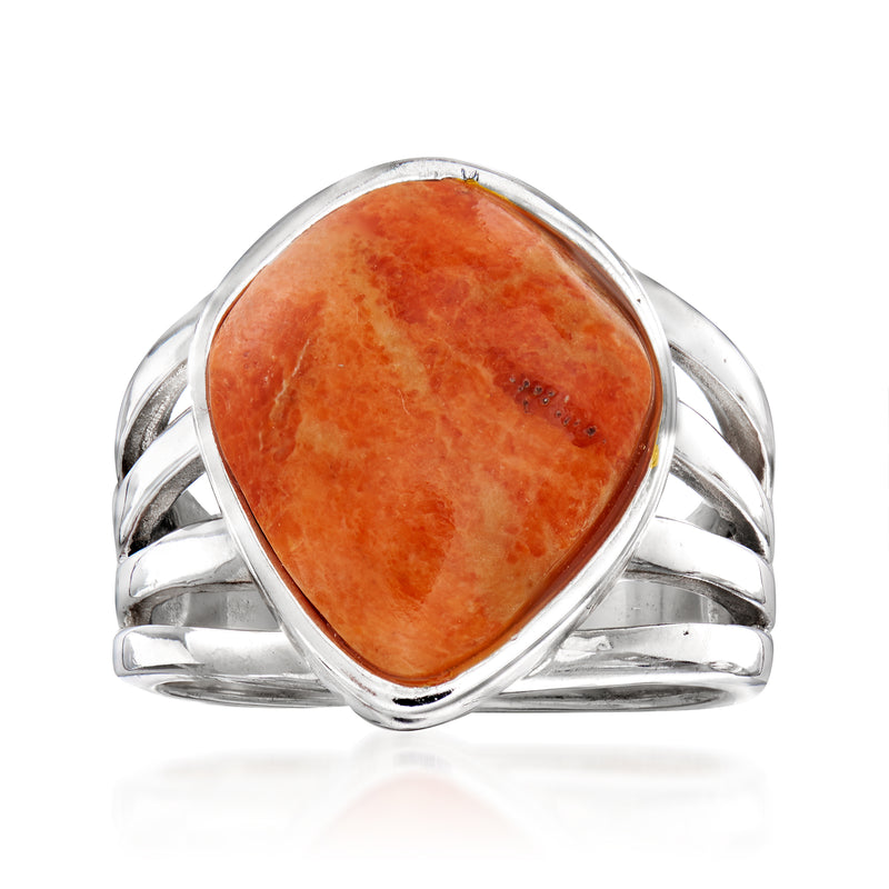 Sterling silver open-space ring with coral-colored oval cabochon stone
