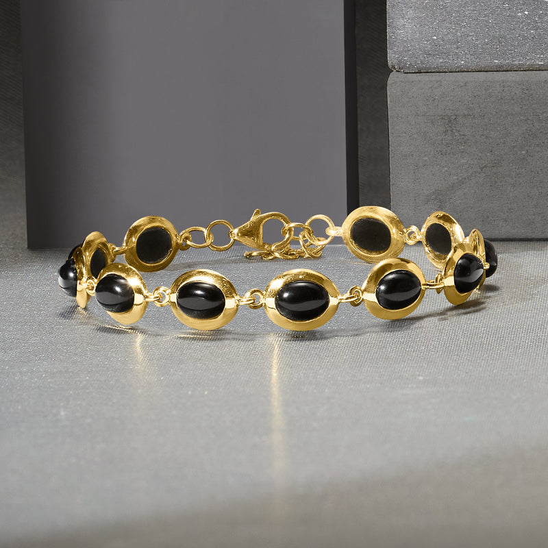 Gold-tone black oval cabochon bracelet with chain links and lobster clasp