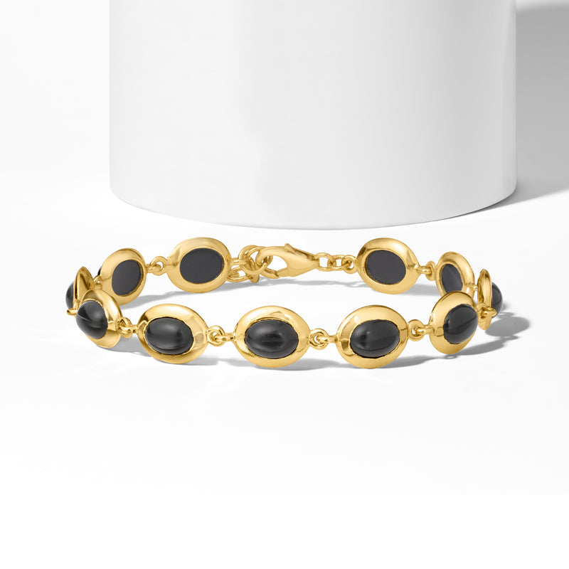 Black oval onyx cabochon bracelet in gold-tone with center chain links