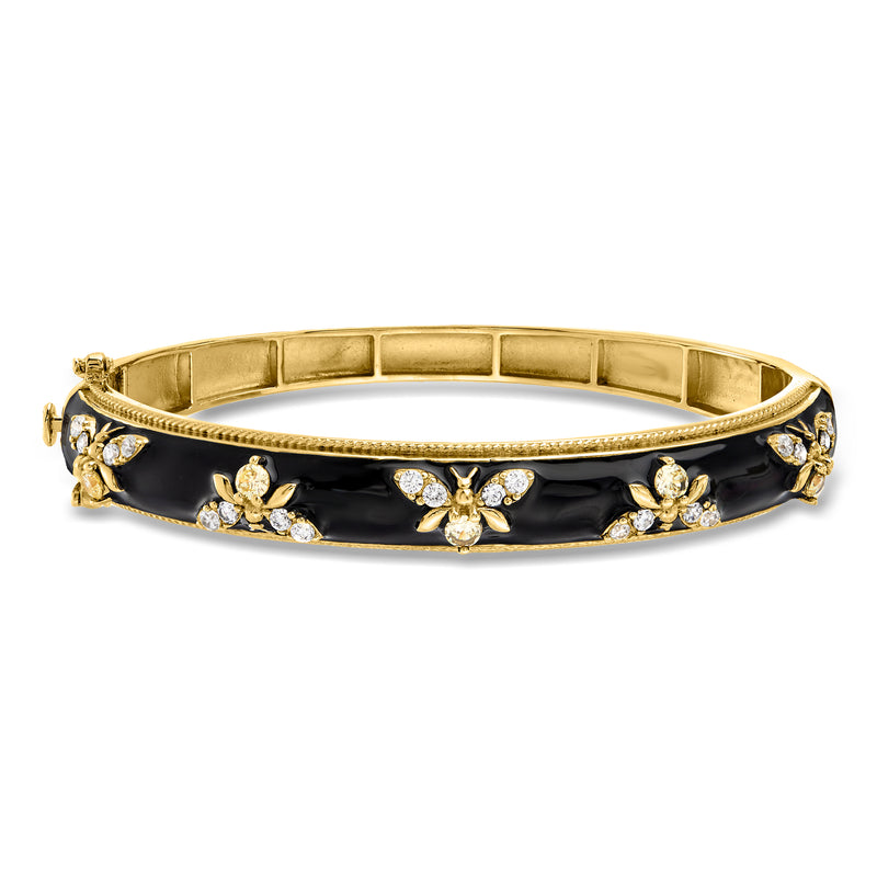 Gold bangle bracelet with black enamel, clear gemstone bee accents and hinged clasp