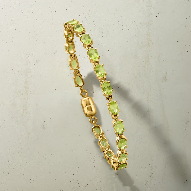 Gold peridot tennis bracelet detail with magnetic clasp and green oval gemstones