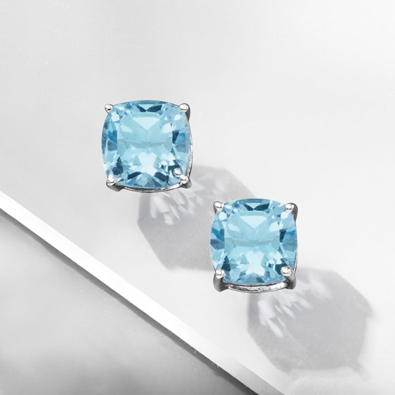 Sterling silver stud earrings with cushion-cut sky blue topaz, four-prong setting
