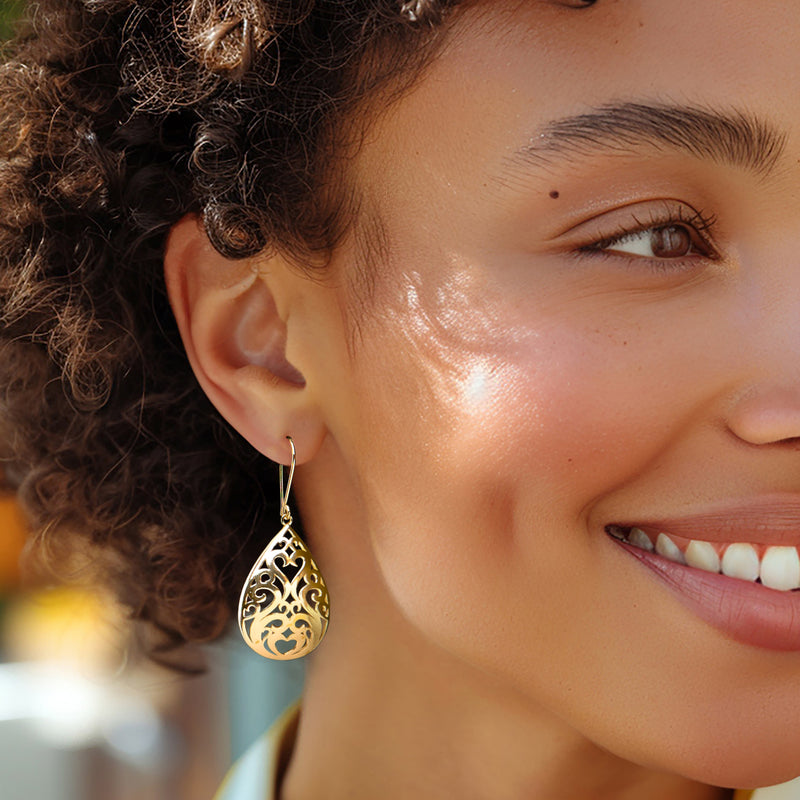 Gold-tone filigree teardrop drop earrings on earwire, shown from the side
