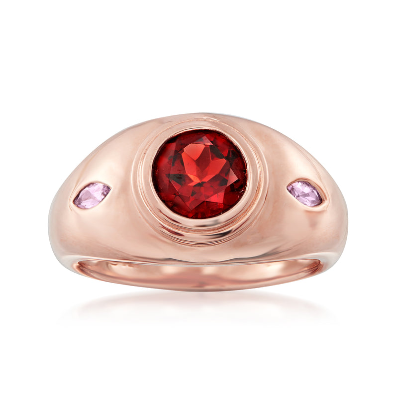 Rose gold ring with red oval garnet center and two purple amethyst side stones