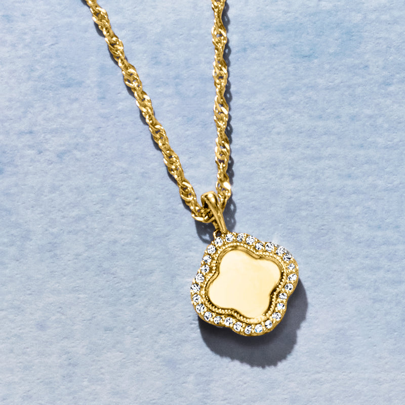 Gold clover pendant necklace with diamond-set border and open center