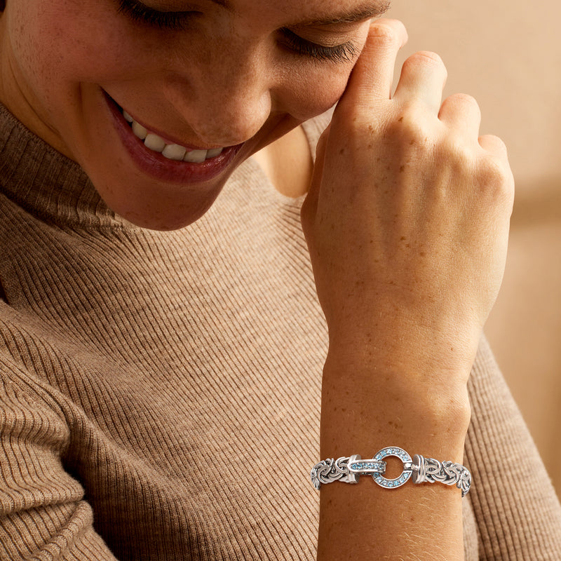 Sterling silver Byzantine bracelet with blue gemstone circle clasp on wrist