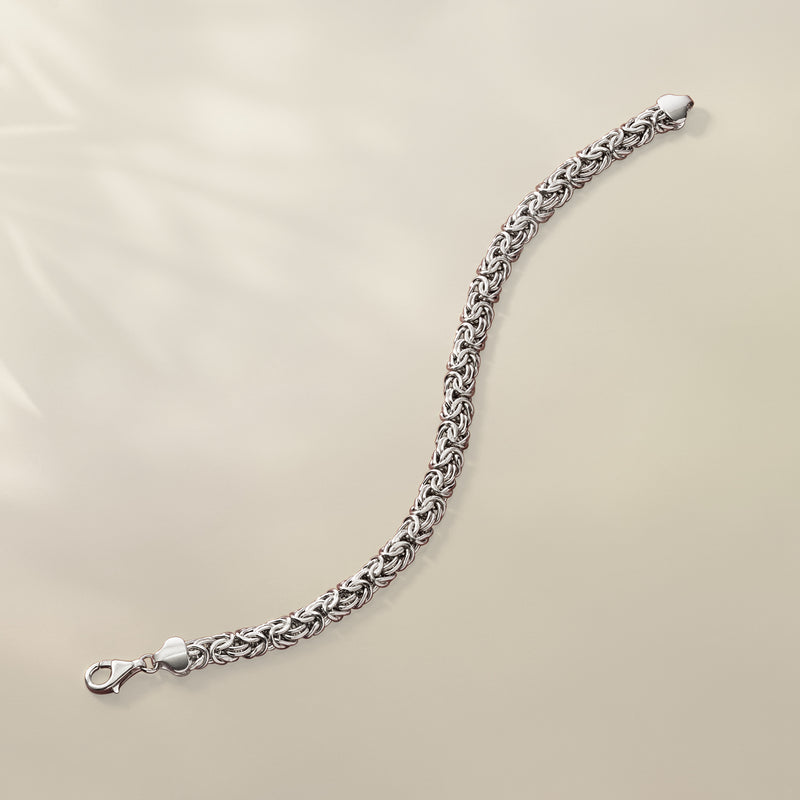 Sterling silver Byzantine chain bracelet with lobster clasp end, shown in profile