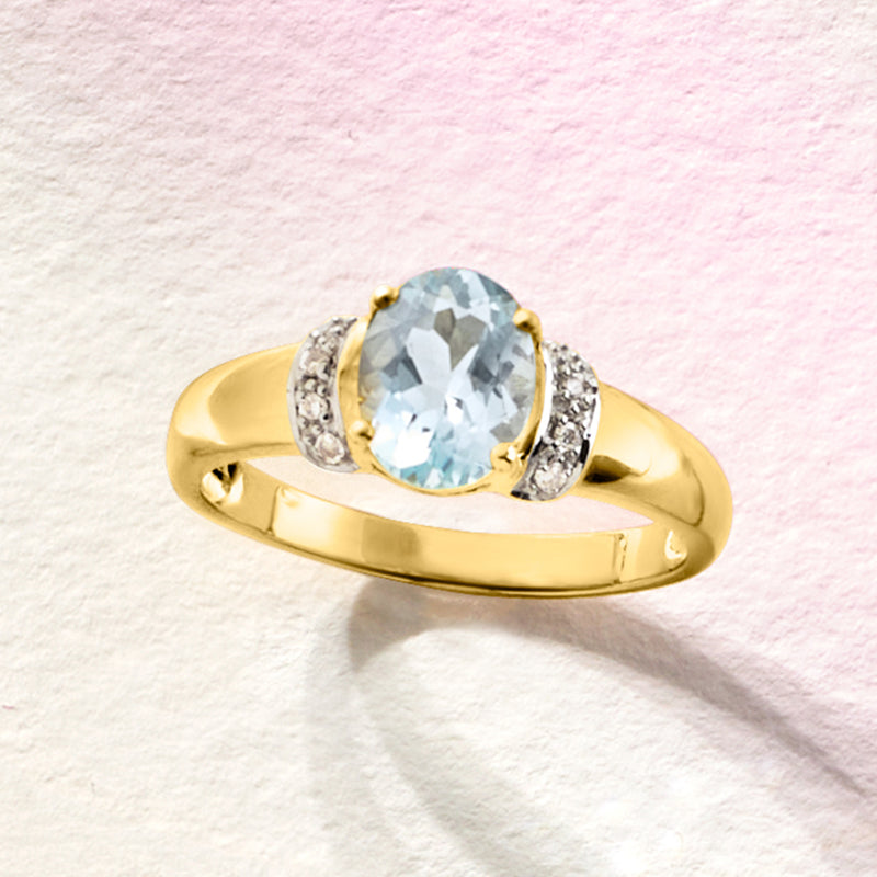 14kt yellow gold aquamarine ring with oval center stone and diamond halo
