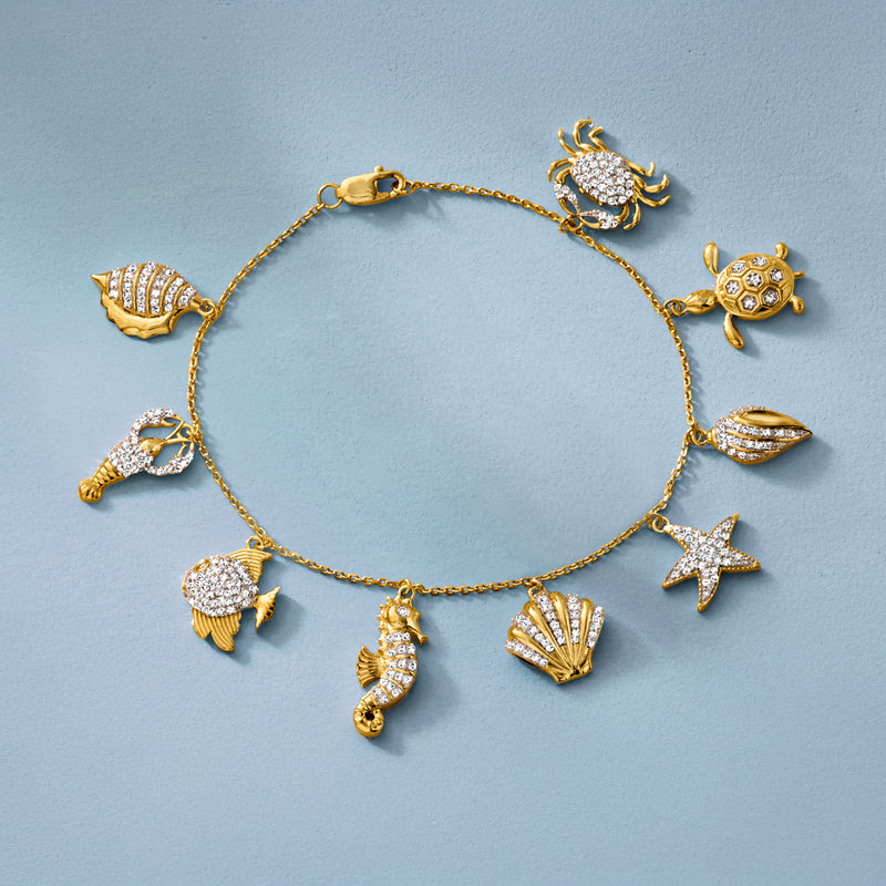 Gold sea life charm bracelet with diamond-like crab, turtle, starfish, fish, and shell charms