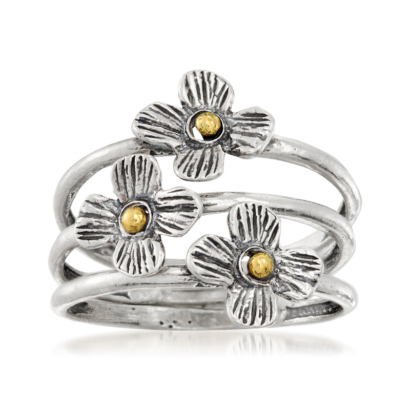 Flower ring set with three sterling silver bands, each with a yellow gold center
