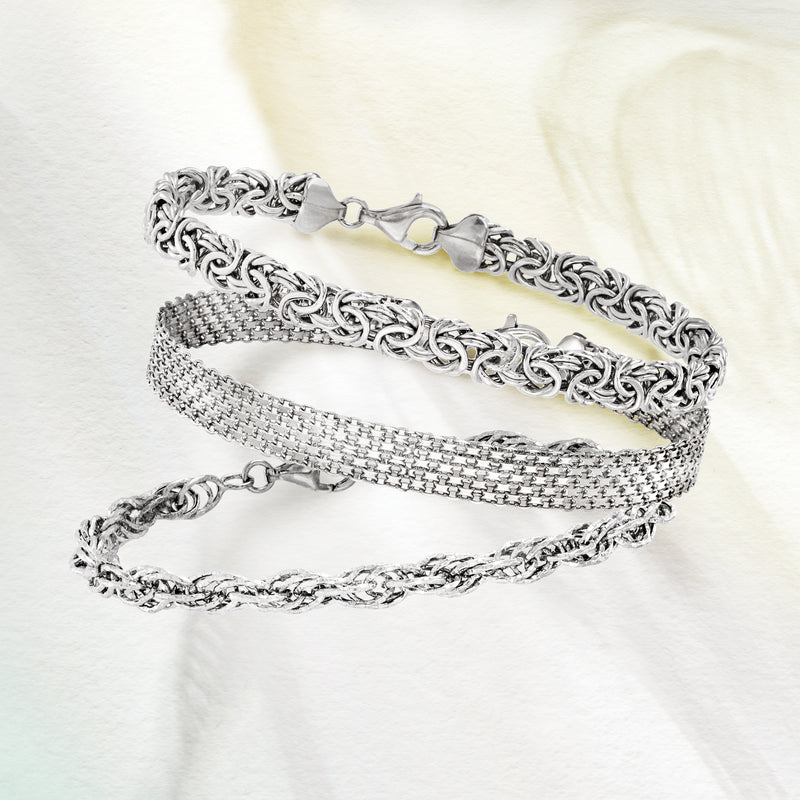 Sterling silver three-link bracelet set with filigree, oval links, and mesh bands with clasps