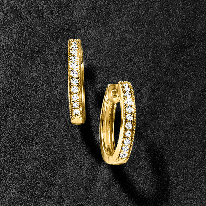 Gold hoop earrings with milgrain texture and diamond row detail, close-up view
