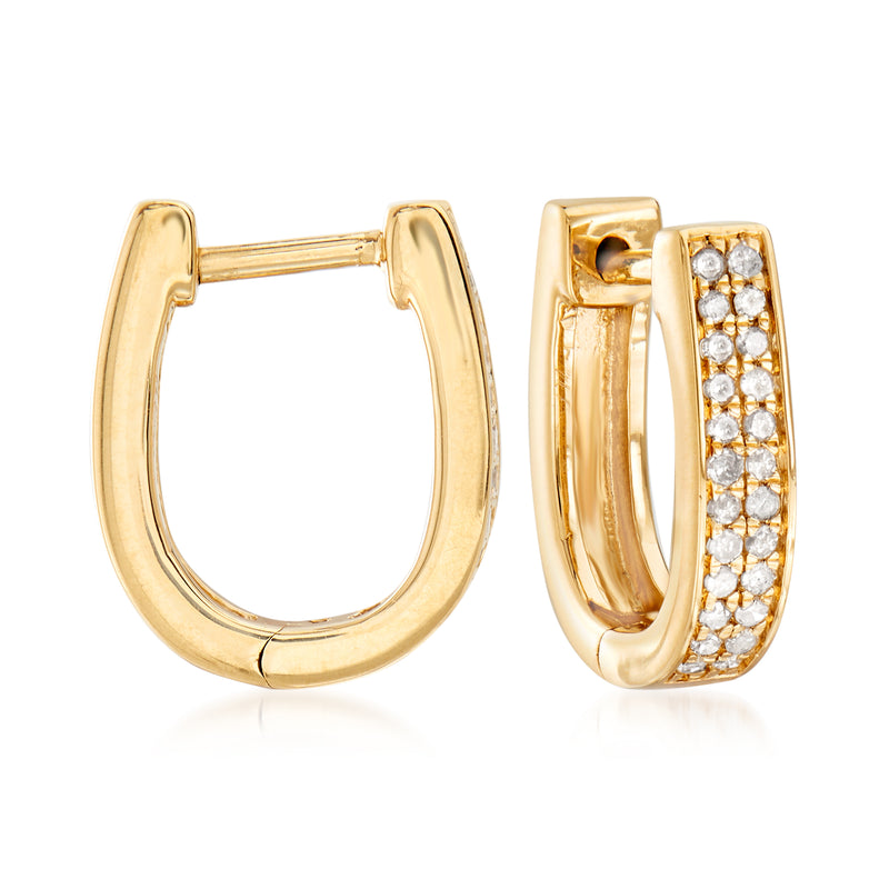 Gold oval hoop earrings with half-set sparkling stones, hinged backing.