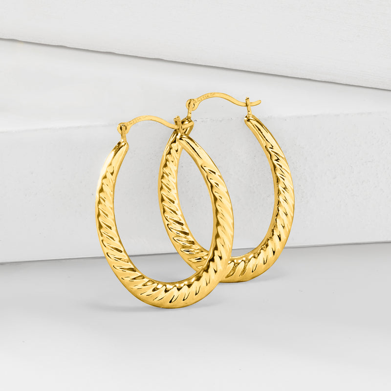 Twisted-oval yellow gold hoop earrings with textured spiral detail
