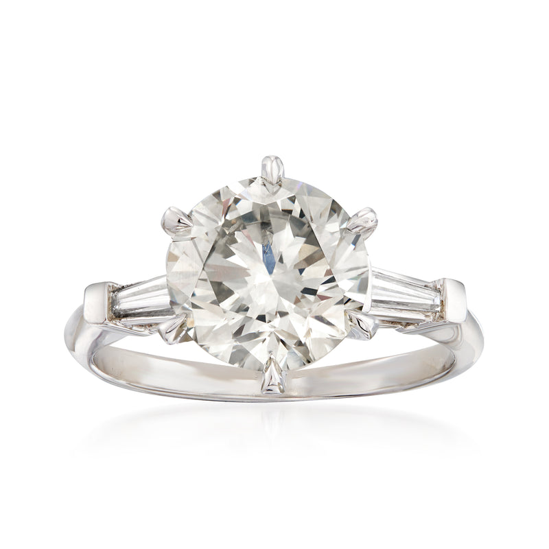 Platinum diamond ring with round center stone and baguette side stones
