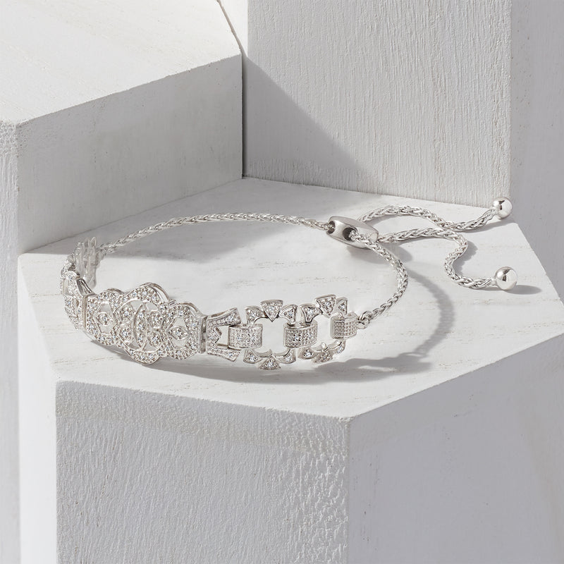 Sterling silver diamond openwork bolo bracelet on display, with round center and toggle ends