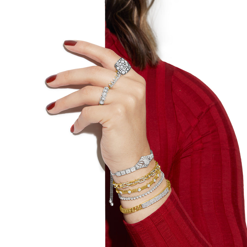 Sterling silver diamond floral openwork bolo bracelet on a wrist