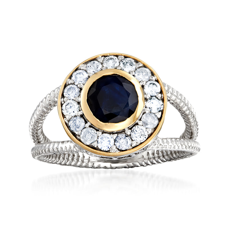 Sterling silver ring with oval dark blue sapphire center and round diamond halo