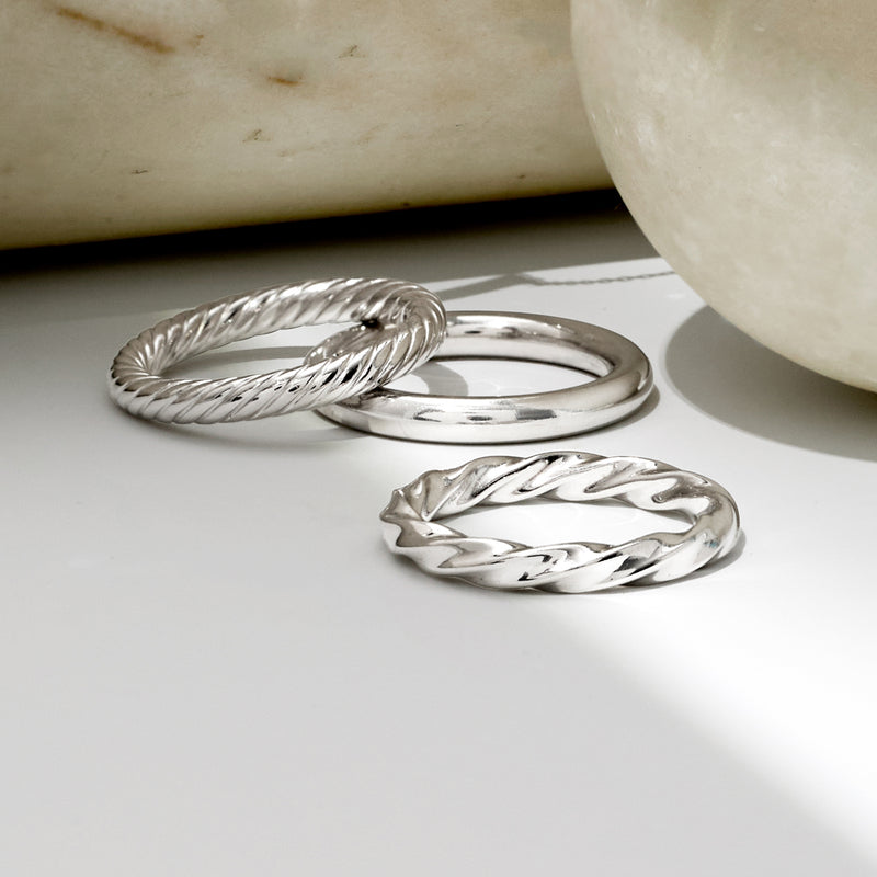Sterling silver three-ring set with braided rope band and polished wavy/oval bands
