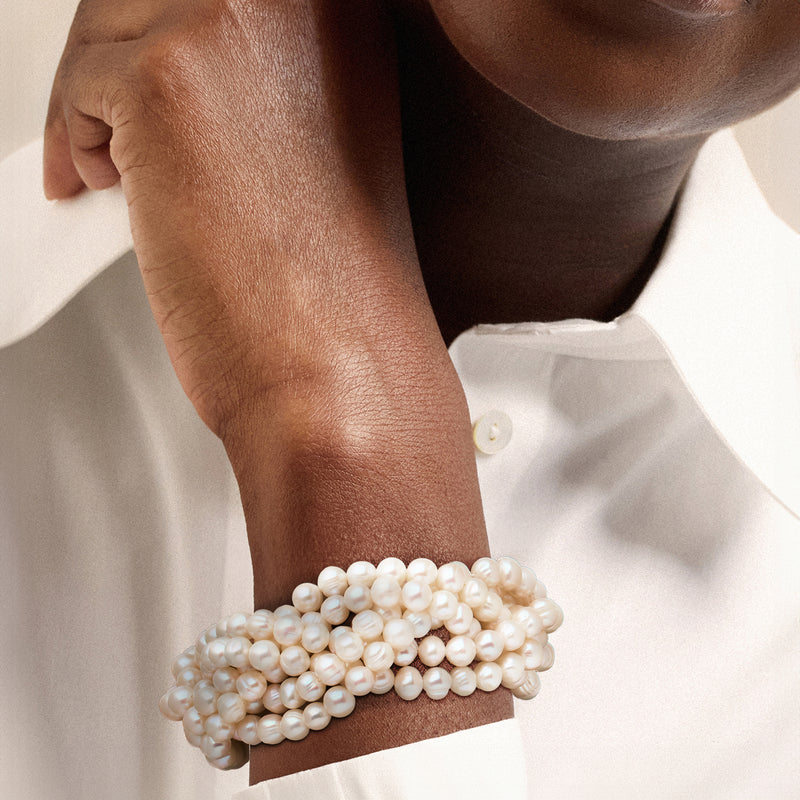 Braided cultured pearl stretch bracelet on wrist with white 6–7mm beads