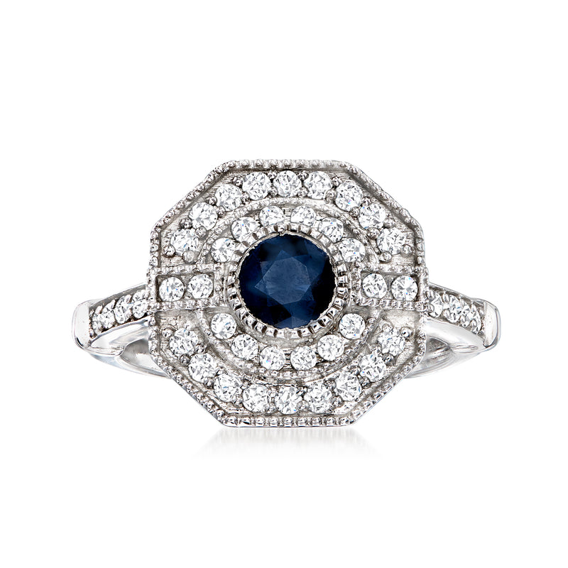 Sterling silver ring with oval dark blue sapphire center and round diamond halo