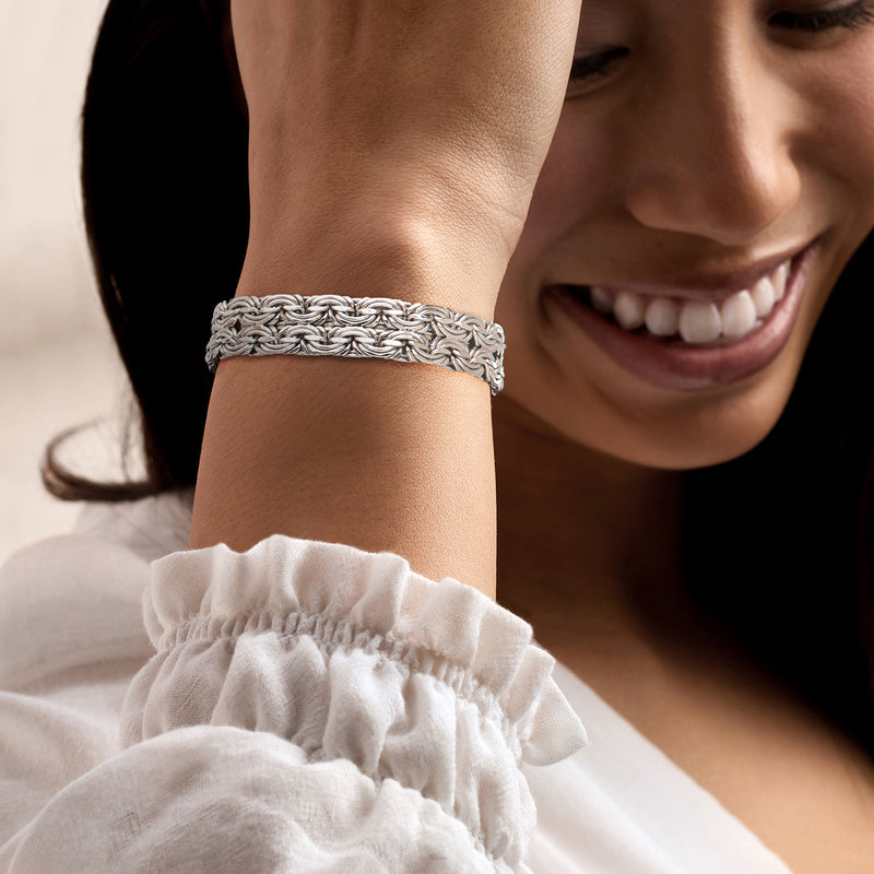Sterling silver wide Byzantine bracelet worn on wrist, polished chain detail