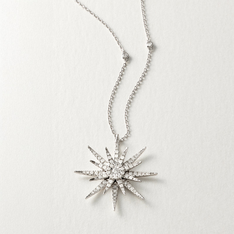 Sterling silver diamond starburst pendant necklace, side view with chain