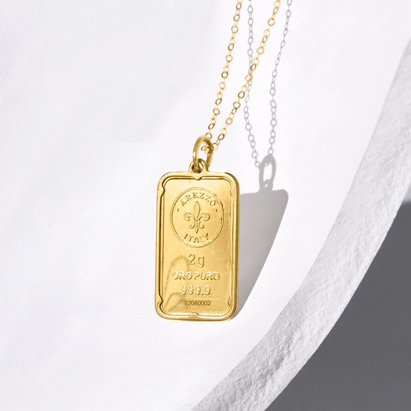 24kt yellow gold ingot pendant with fleur-de-lis marks, shown on chain