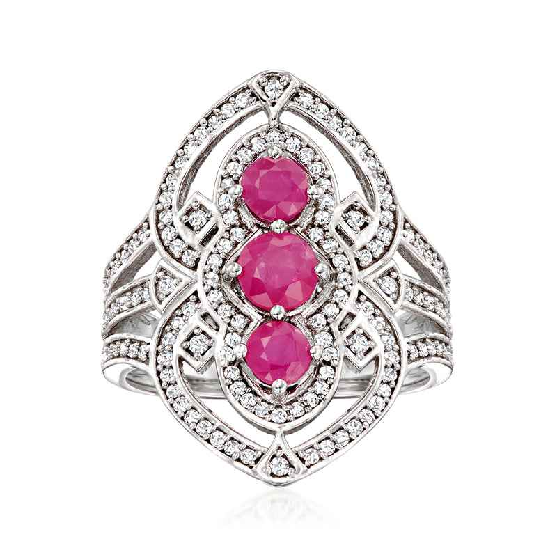 Sterling silver ring with three ruby-style pink stones and diamond halo accents