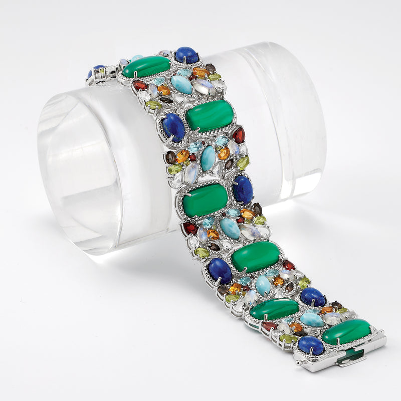 Sterling silver multi-gem bracelet angled view with green rectangular and blue oval stones