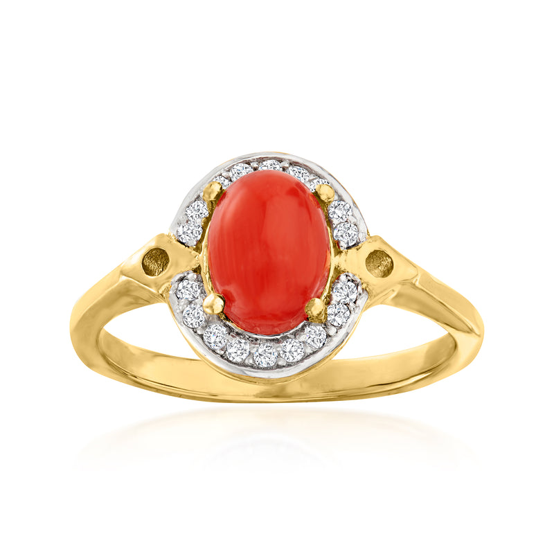 Gold ring with oval red coral cabochon, diamond halo, and round diamond accents