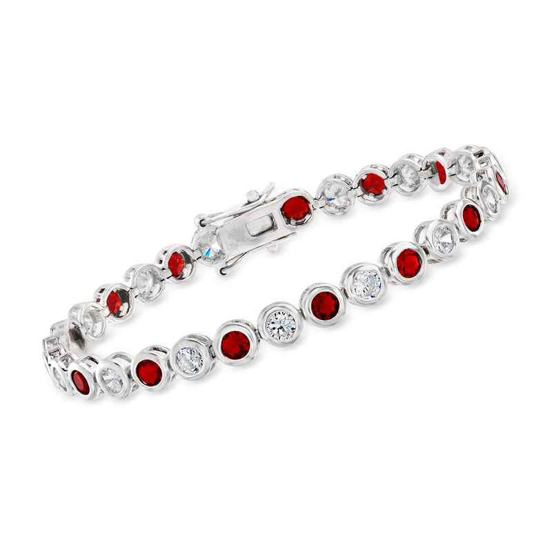 Silver-tone tennis bracelet with bezel-set round red and clear stones, flexible links.