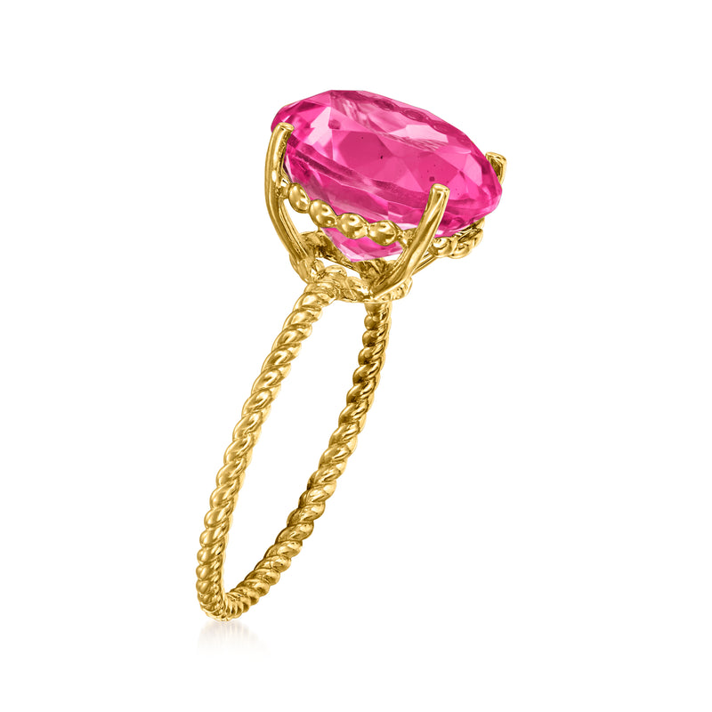 Oval pink gemstone ring with twisted 14kt yellow gold band, side view