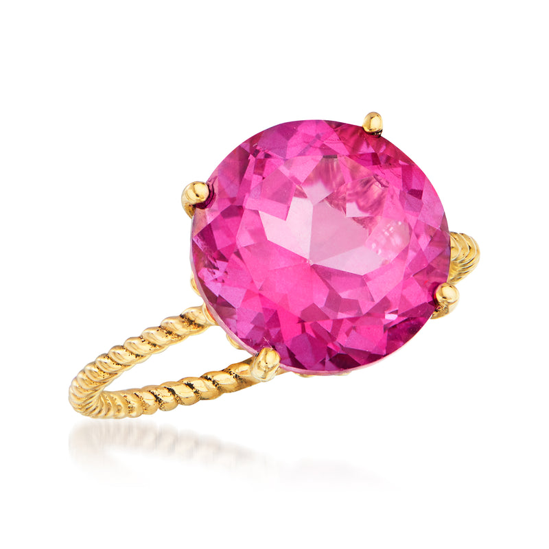 Round pink gemstone ring on twisted 14kt yellow gold band, angled view