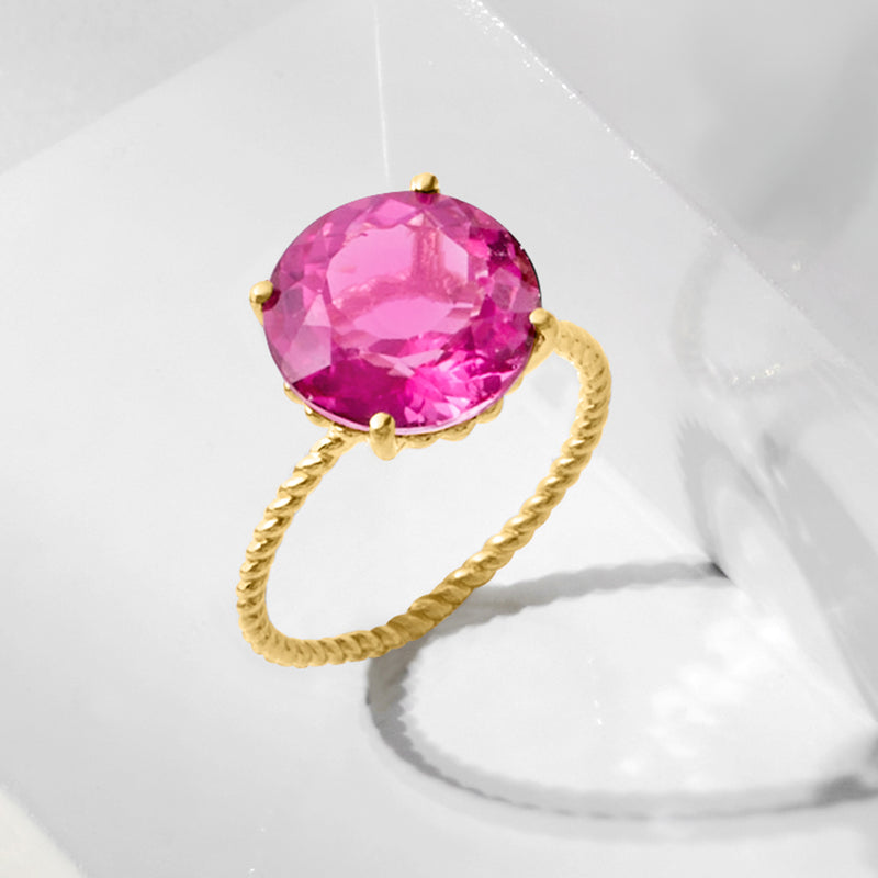 Pink gemstone ring with twisted 14kt yellow gold band, top view