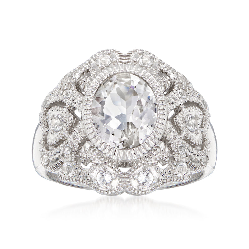 Sterling silver scrollwork ring with oval white topaz center and halo of clear stones